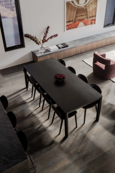 Black dining table with chairs in renovated space