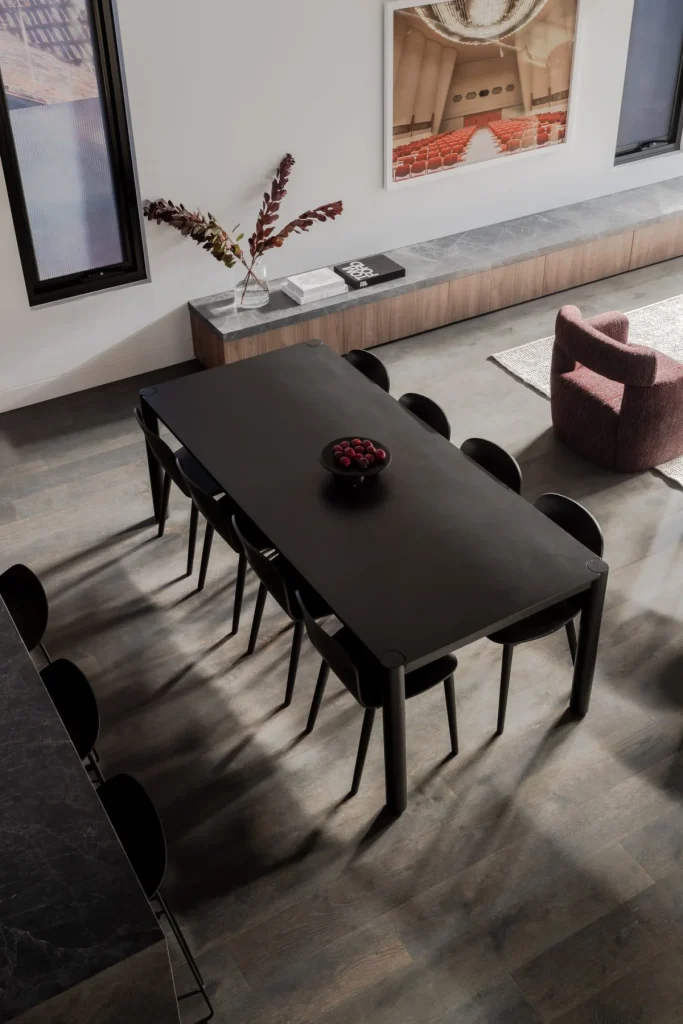 Black dining table with chairs in renovated space