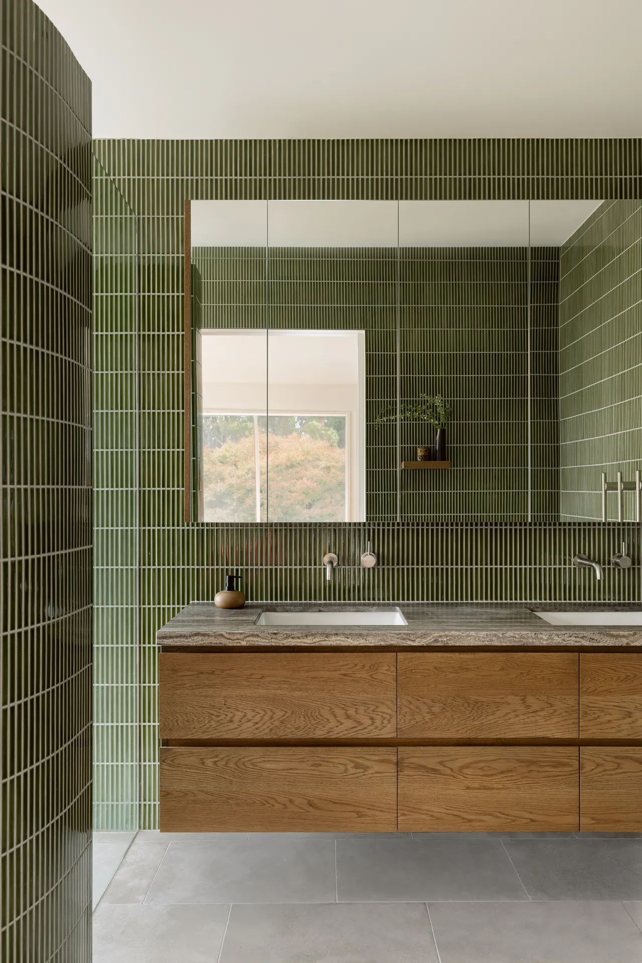 Merricks bathroom with green vertical stack tile and oak double vanity